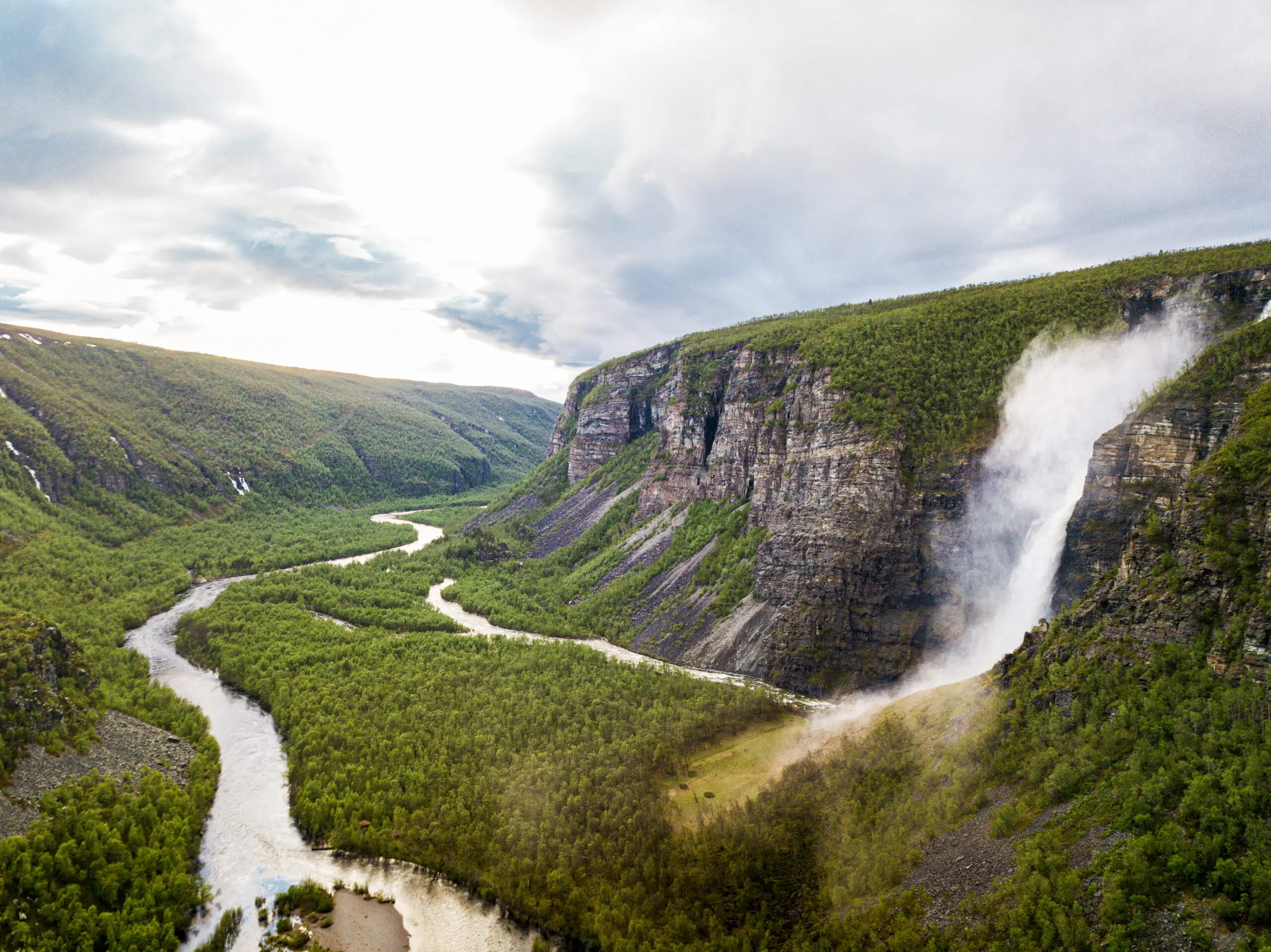 Aerial view of Mollisfossen waterfall and the winding Reisa River in Reisa National Park, Norway