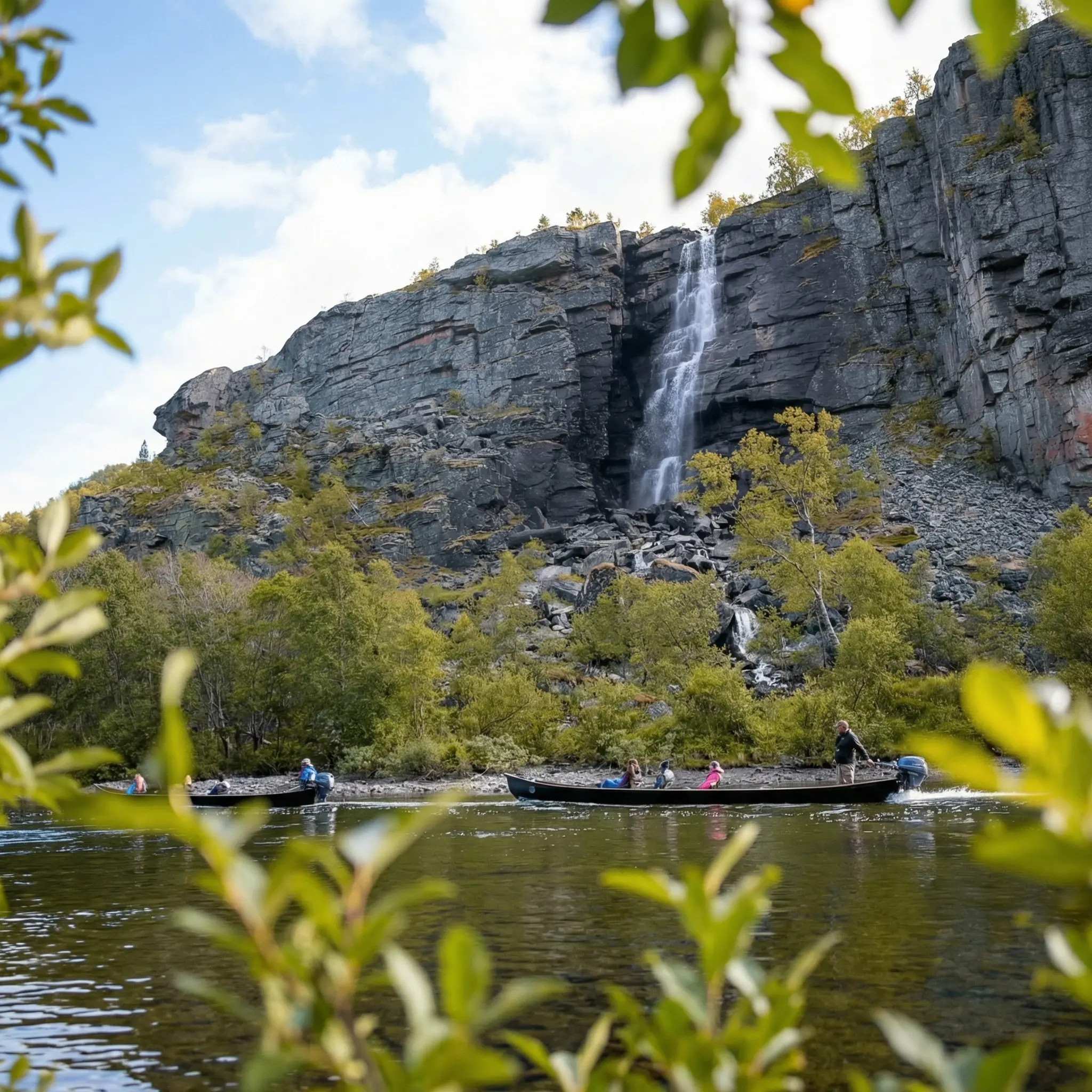 Riverboats passing a waterfall cascading down the canyon walls along the Reisa River, Reisa National Park